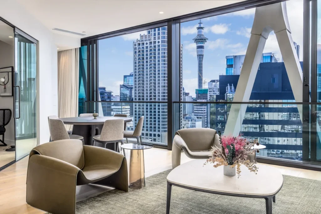 Luxury Auckland apartment interior with floor-to-ceiling windows framing the Sky Tower